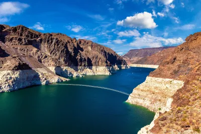 Colorado River at Lake Mead with low water line visible on rocks.