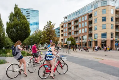 Group of people on bikes at intersection. in downtown, Denver. CO.