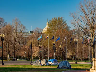 Tents used by homeless people in Washington, D.C. with Capitol dome in background.