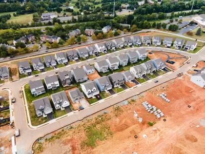 Aerial view of dense single-family homes in neighborhood still under construction