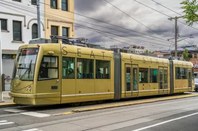 Gold Seattle Streetcar on street against stormy gray sky