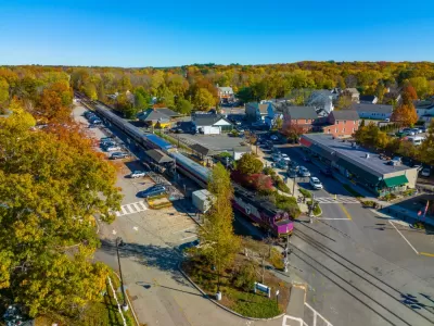 Aerial view of MBTA commuter rail station in Concord, Massachusetts among green trees