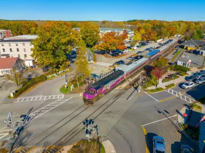 Aerial of purple train in station in small town Concord, Massachusetts.