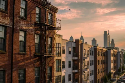 Brick apartment buildings with Phialdelphia skyline in the background.