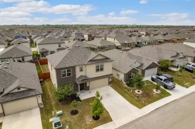 Low aerial view of two-story suburban Houston homes