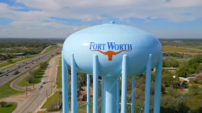 Light blue water tower with Fort Worth logo and orange longhorn cow head sillhouette.