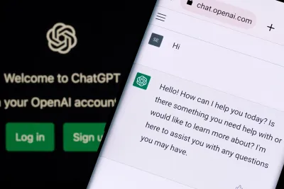 ChatGPT chat bot screen seen on smartphone and laptop display with Chat GPT login screen on the background.
