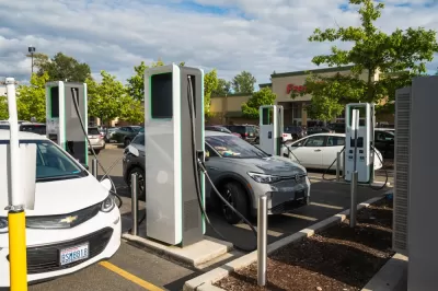 Electric car charging station with several Chevy Bolts charging in parking lot of store in Bellingham, Washington