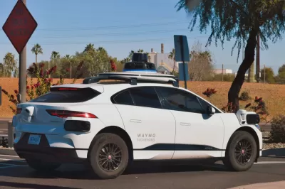 Self-driving white Waymo Jaguar SUV on street in Chandler, Arizona