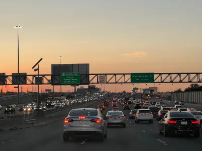 Rush hour traffic on freeway in Houston, Texas at sunset.