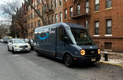 Rivian electric Amazon delivery van delivering packages curbside on New York City street