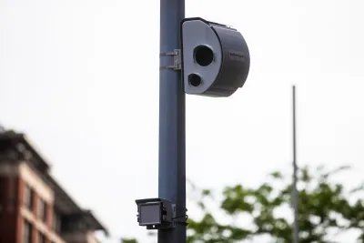 White traffic camera mounted on a pole.
