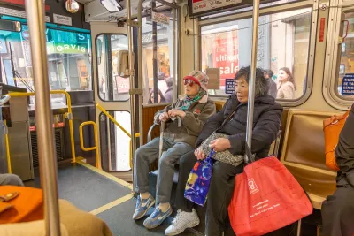 Two women sit inside a Metropolitan Transit System streetcar.