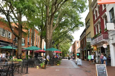 Walkable red brick street with restaurant patios and small shops in Charlottesville, Virginia.