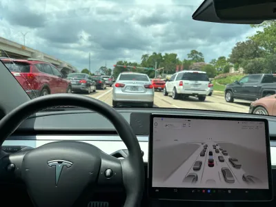 Interior of TEsla vehicle facing out from driver's seat.
