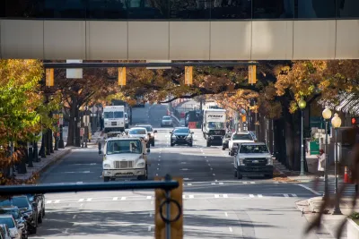 A busy road in Charlotte, NC, with cars driving towards an elevated camera.