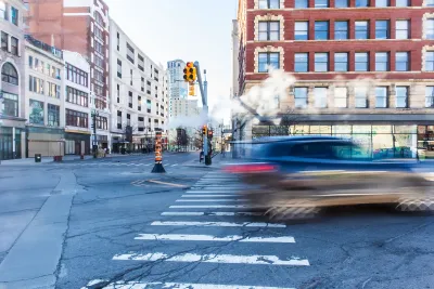 Blurred car passing through crosswalk in downtown Detroit, Michigan.