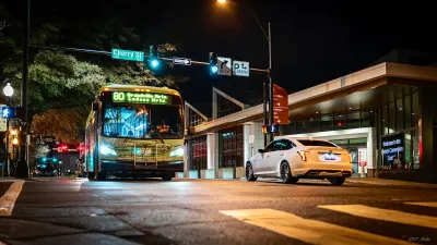 Winston-Salem transit bus on street at night.