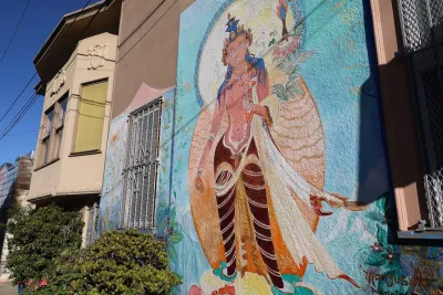 Mural of Asian deity on building in San Francisco.