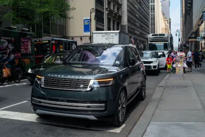 Dark-colored Range Rover SUV on street in Manhattan, New York City.