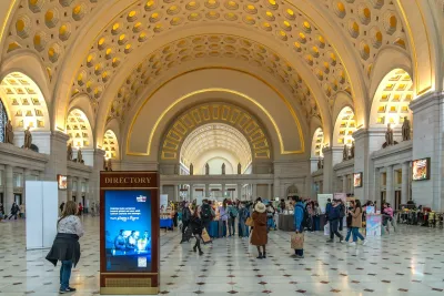 Main hall with arched ceiling and alcoves filled with people in Union Station, Washington DC.