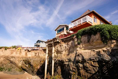 Home perched on steep cliff almost falling due to erosion.