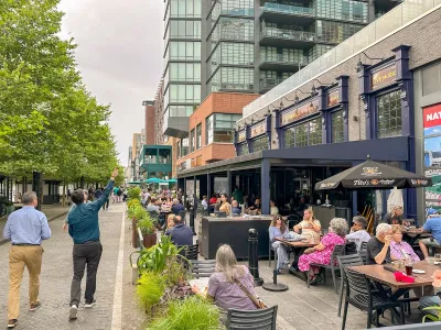 Outdoor dining tables full of customers on a street in Washington DC.