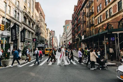 Pedestrians in NYC cross the street.