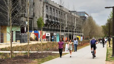 People walking and biking on Atlanta Beltline paved trail.