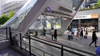 Silver and glass angled entrance to Penn Station subterranean train station in New York City.