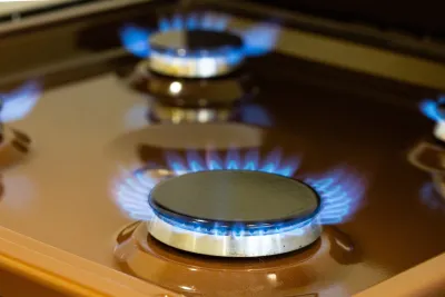 Close-up on blue flame on natural gas kitchen stove.