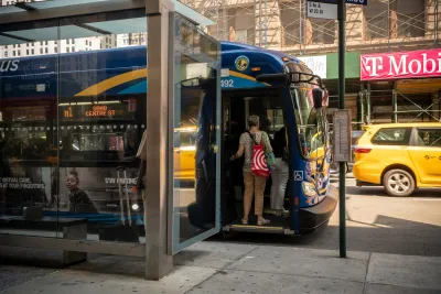 Person boarding blue city bus at New York City bus stop.