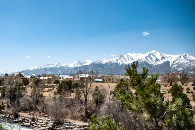 View of small mountain town of Buena Vista, Colorado with snow-capped mountains in background.
