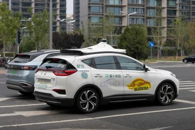 White Baidu self-driving car on street in China.