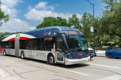 A texas bus drives down a multi lane road