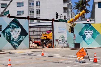 Construction site for Los Angeles Metro underground station with Beverly Hills city logo on construction fences.
