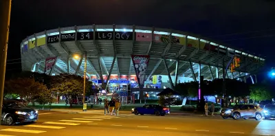 Fans walking away from Flying Squirrels minor league baseball stadium in Richmond, Virginia at night.