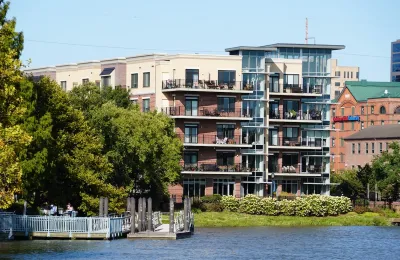 Four story apartment building with balconies on lake or river in Wilmington, Delaware.