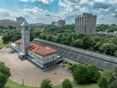 Aerial of historic Mount Royal gray train station with red tile roof in Baltimore, Maryland.