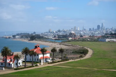 View of Spanish-style buildings in Presidio, San Francisco with city skyline in background.
