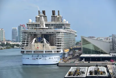 Large white cruise ship docked in port in Miami, Florida.