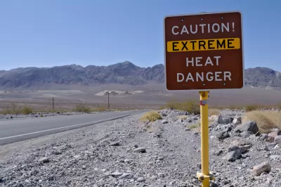 "Caution! Extreme heat danger" sign in Death Valley National Park with desert mountains in background