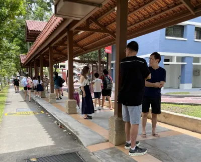 People standing under a covered walkway in Singapore