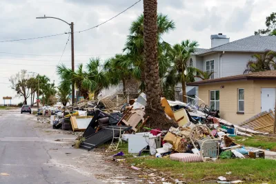 Houses with debris from hurricane piled on front lawns in Florida.