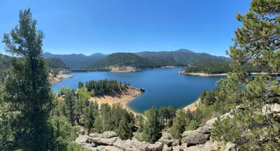 The Gross Reservoir, a large body of water surrounded by trees and mountains.