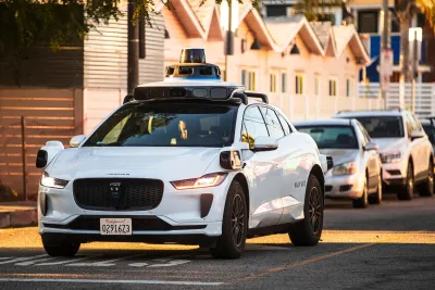 White Waymo self-driving taxi in Los Angeles, California.