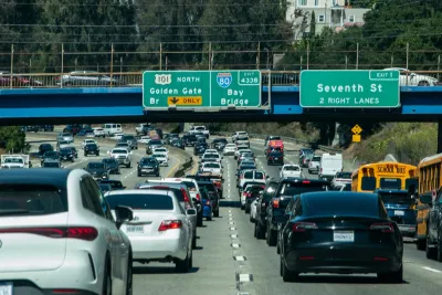 Busy freeway in Northern California with green signs for Golden Gate and Bay Bridges.