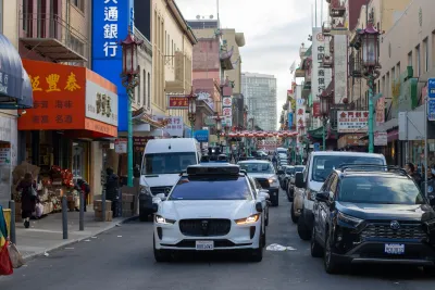 White Maymo robotaxi seen from front stopped at intersection in Chinatown in San Francisco, California.