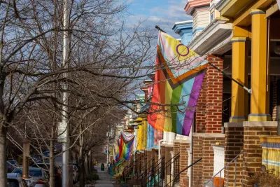 Rainbow flags on brick row houses in Baltimore, MD.