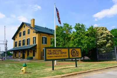 Yellow wooden building housing historic train depot in Huntsville, Alabama.